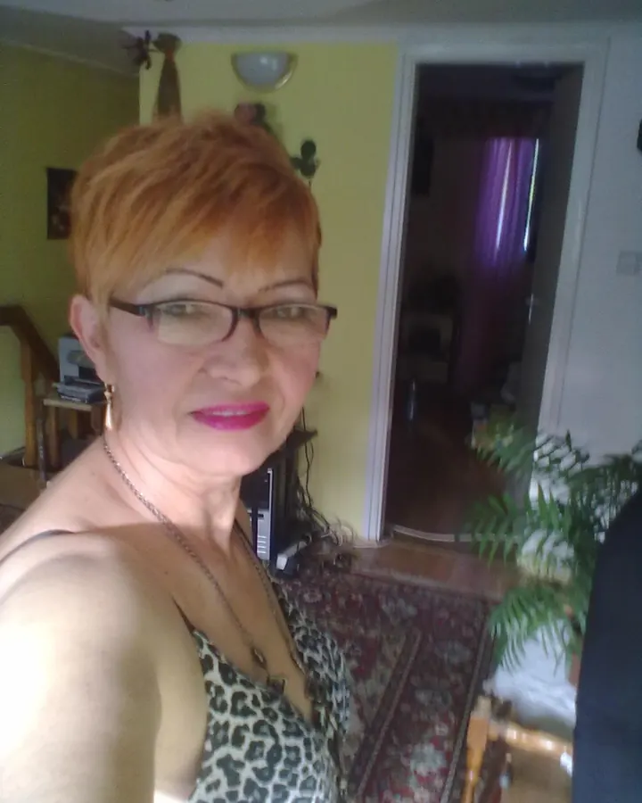 Femme en haut léopard, lunettes, souriant, dans un salon